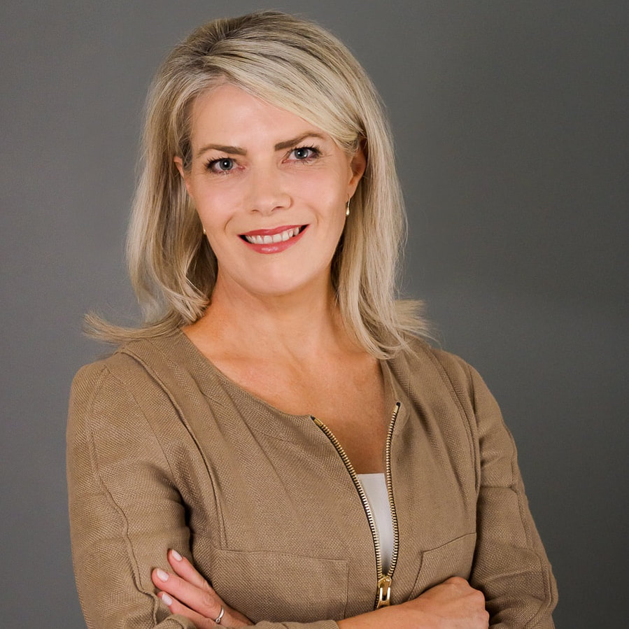 Business headshot of a professional woman against a dark background.
